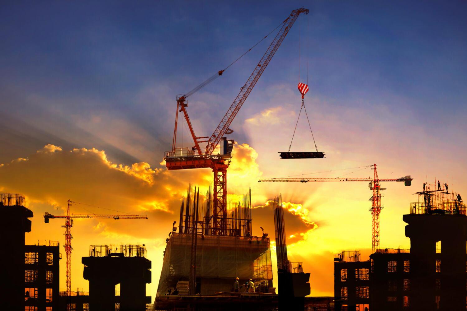 big crane and building construction against beautiful dusky sky use for construction industry and engineering